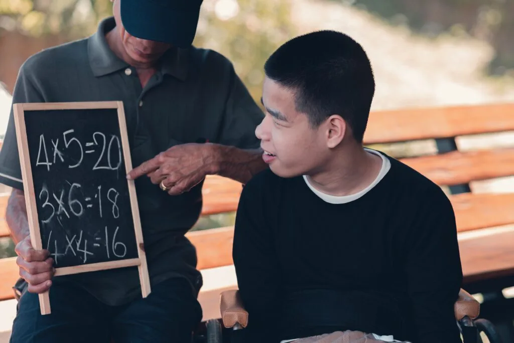 Parent using communication techniques with special needs child using visual supports