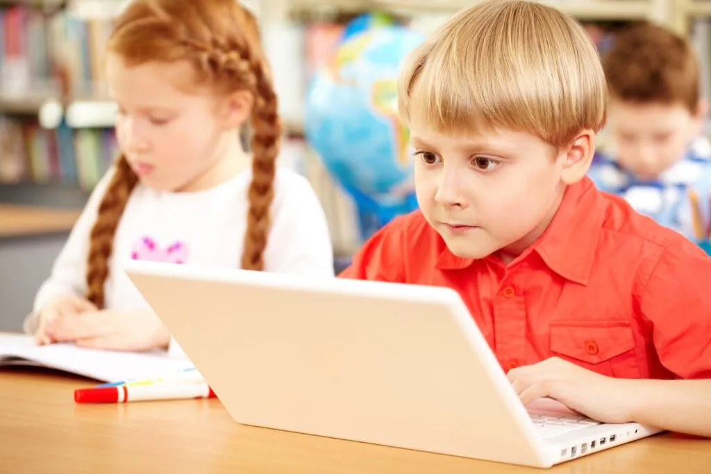 Child with special needs using assistive technology device for learning at home