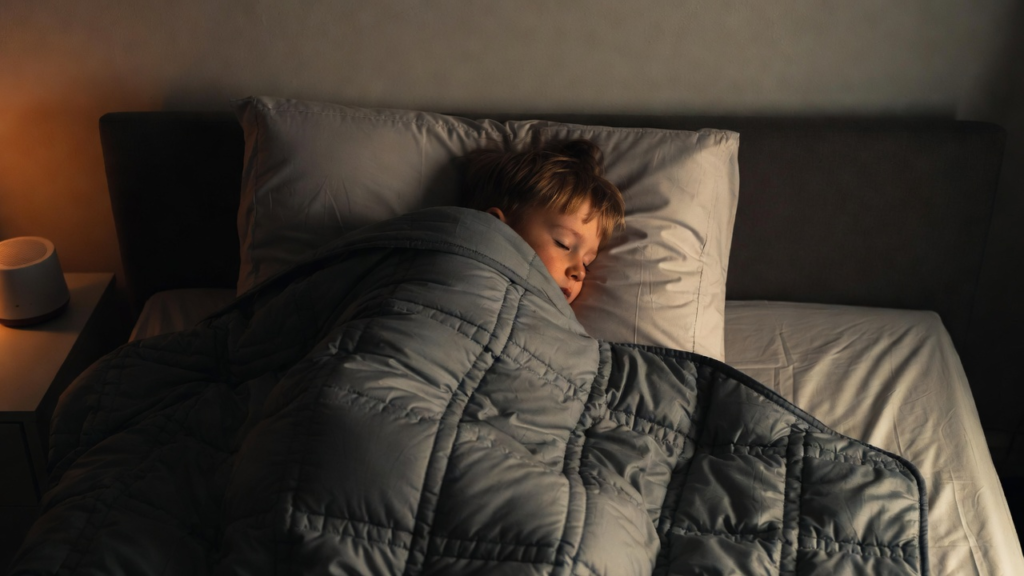 A child with autism sleeping peacefully under a weighted blanket — deep pressure stimulation for better sleep and calm