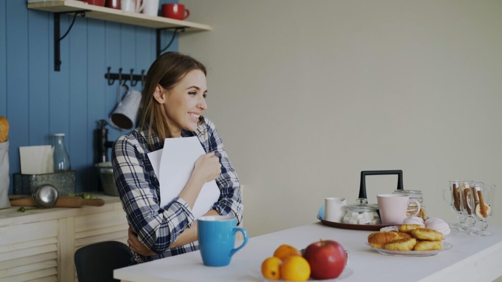 Special needs parent physical health impact: tired mom sitting alone at kitchen table after caregiving