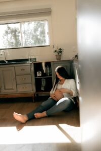 Exhausted mother reading paperwork after learning what to do after autism diagnosis for her child