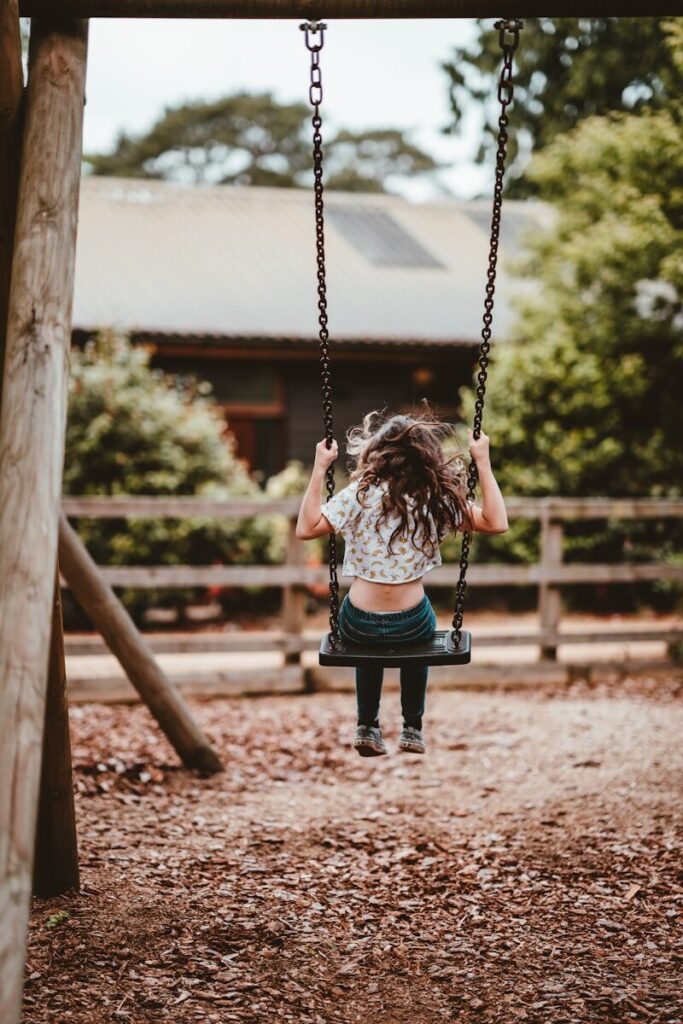 young child using sensory swing for vestibular input autism calming at home