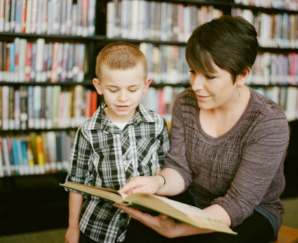 mother teaching autistic child self-advocacy skills reading together