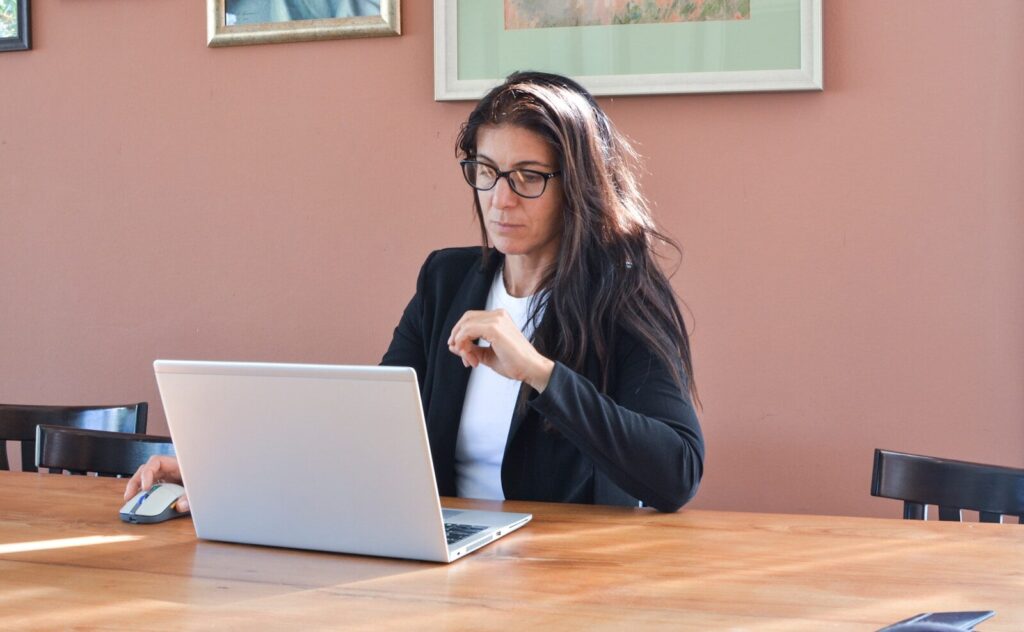 professional woman working at laptop representing special needs parent workplace accommodations and employment rights