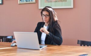 professional woman working at laptop representing special needs parent workplace accommodations and employment rights
