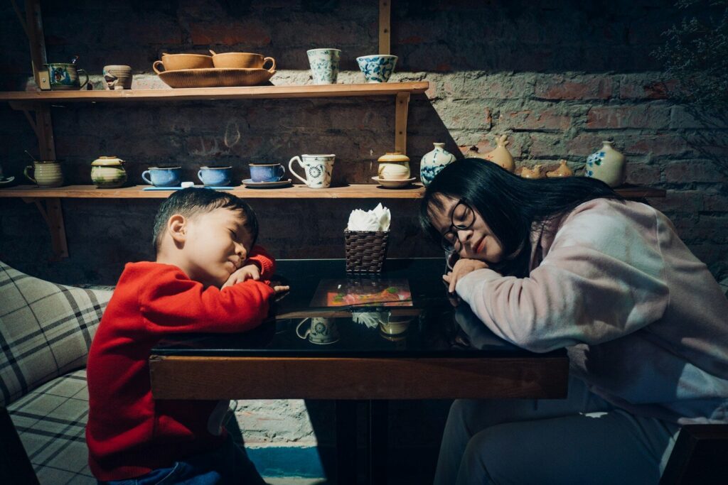 Tired mom sitting beside her child during a therapy plateau, representing autism therapy stalling and what to do next