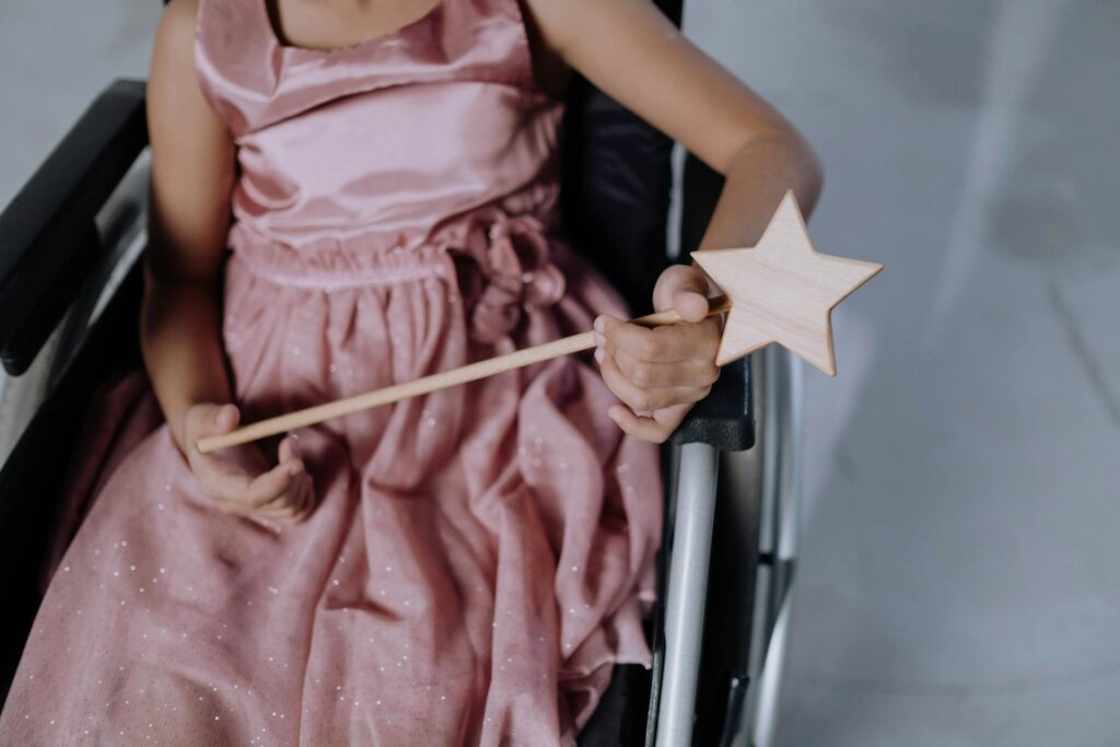 Girl with disability in wheelchair holding a sensory star toy, representing children with cerebral palsy using sensory tools