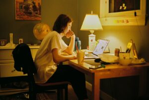Mom doing special needs estate planning paperwork late at night with coffee nearby