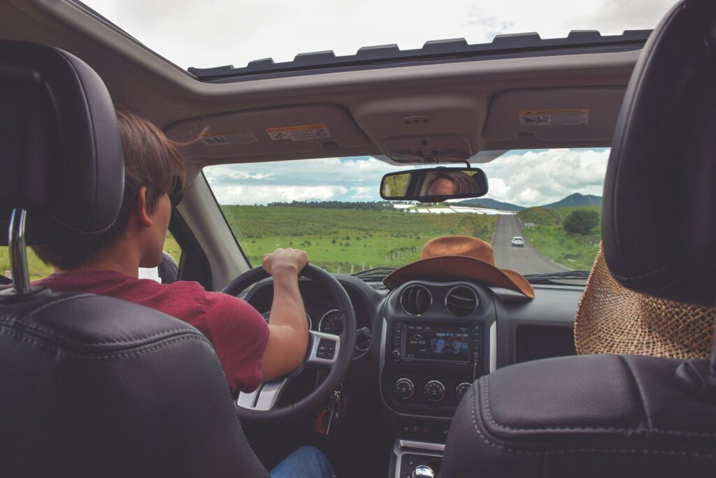autistic teen sitting in car with parent learning if he can drive safely