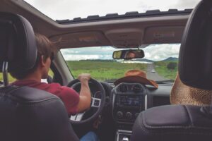 autistic teen sitting in car with parent learning if he can drive safely