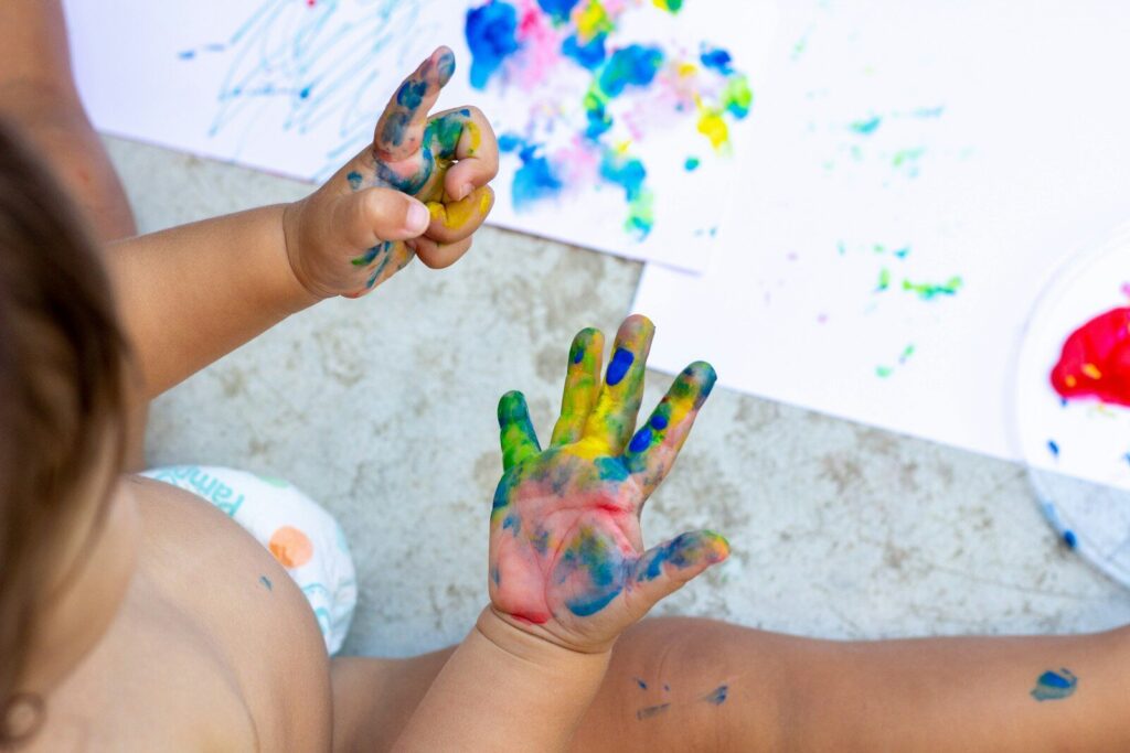 sensory diet for kids - child playing with paint and colors