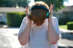 autistic teenager wearing noise-canceling headphones sensory tools age-appropriate