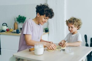 Mom and teen teach autism money management skills using coins and a budget worksheet