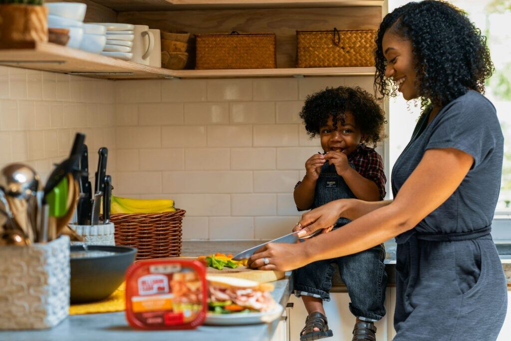 autism gut health connection - mother and child cooking healthy food together in kitchen