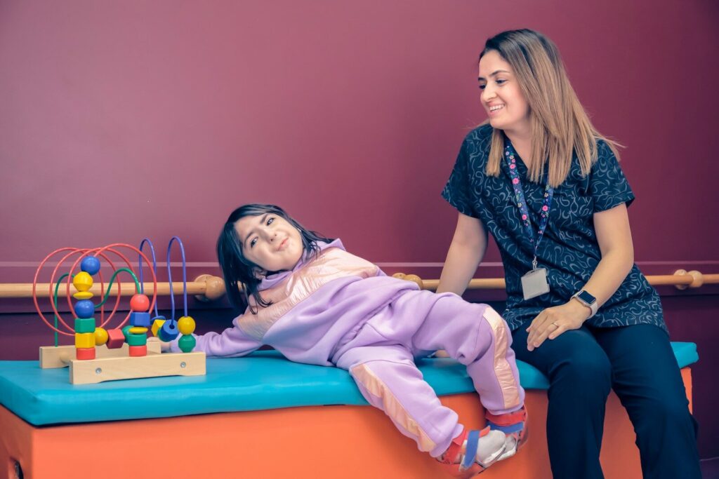 occupational therapist doing sensory evaluation with autistic child using tactile tools