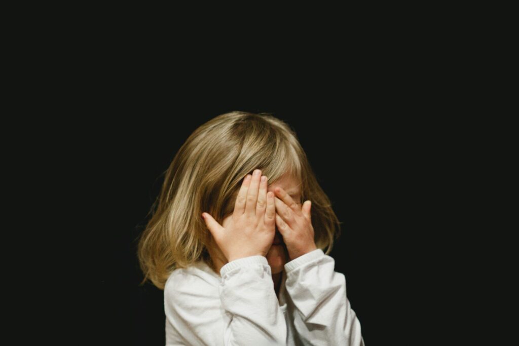 autism smell sensitivity child covering nose from sensory overload at school