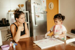 Tired mom at kitchen table because school special education staff don't understand autism and her child's needs