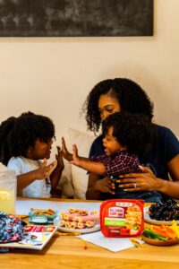 mom helping autistic child with sensory tools at home