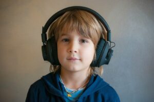 Child wearing noise-cancelling headphones for sensory support