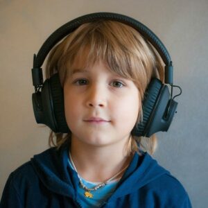 Child wearing noise-cancelling headphones for sensory support