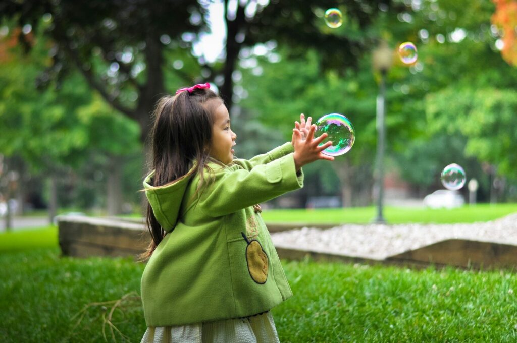 child engaging in sensory play outdoors for autism sensory development